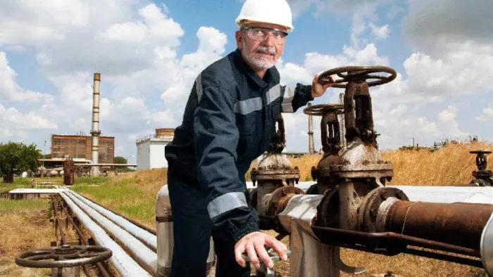 Worker handling a large pipe.