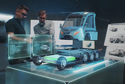 Two men looking at blueprint and car model