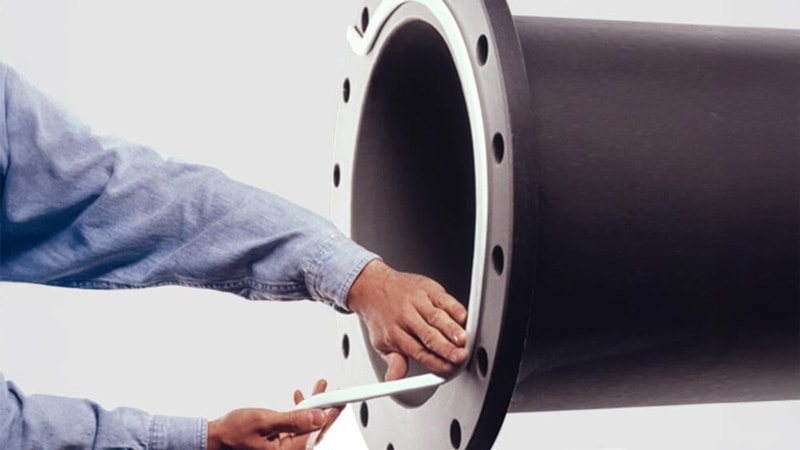 Worker installing Joint Sealant on a large pipe.