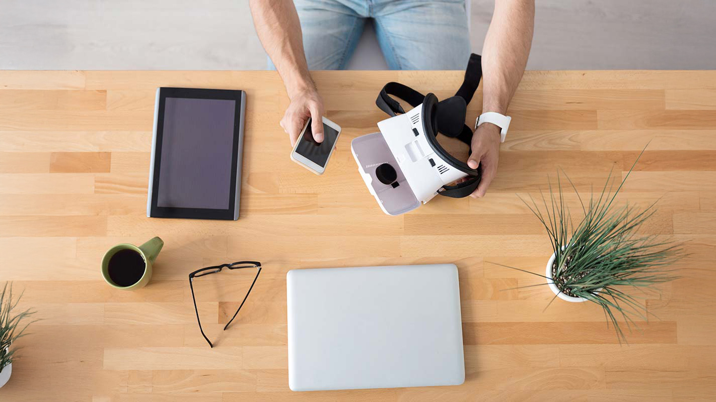 Multiple electronic devices on a table.