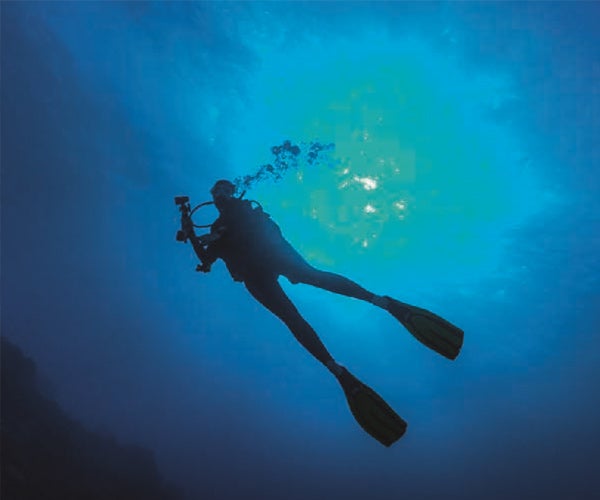 image of a suba diver from below in the water