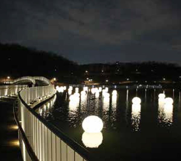 Waterborne Moon Lights floating in the water at night