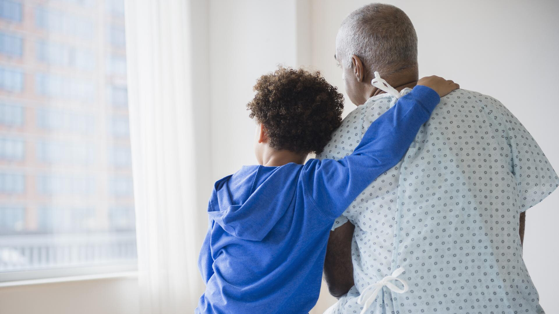 patient and child embracing in hospital room