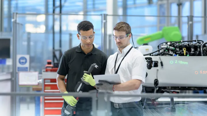 Two specialist reviewing a tablet.