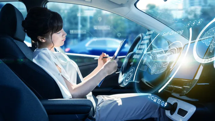 Woman in autonomous car working on a tablet