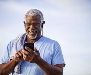 Man using phone and smiling