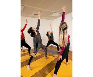 Associates doing yoga in a studio.